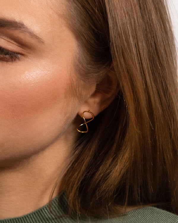 Model wearing Curl Infinity Earring Studs with 24k gold vermeil.